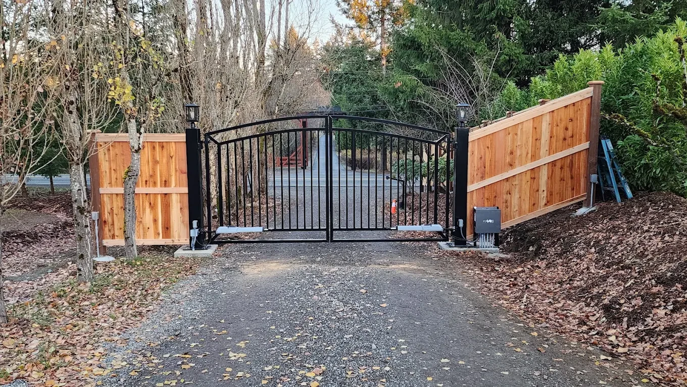Black metal driveway gate wooden fencing