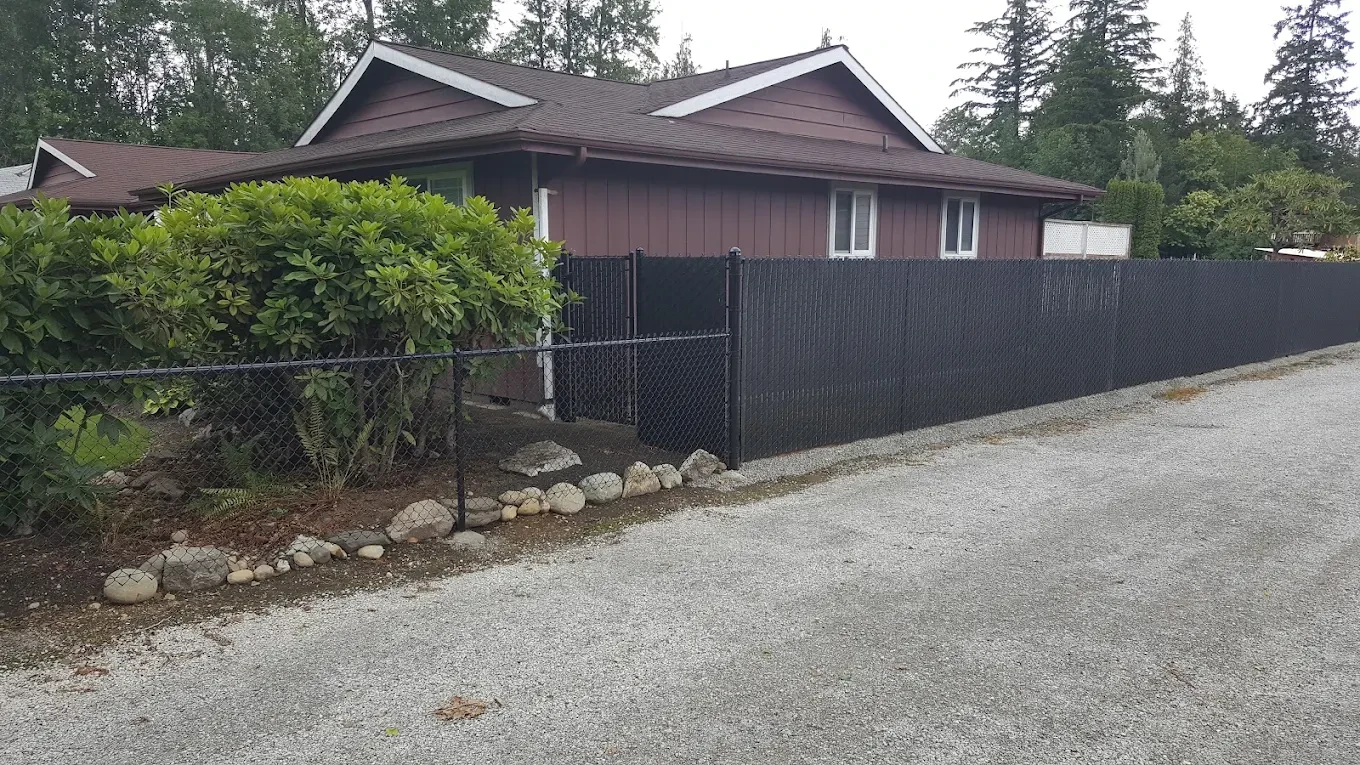 Modern house black fence forested property