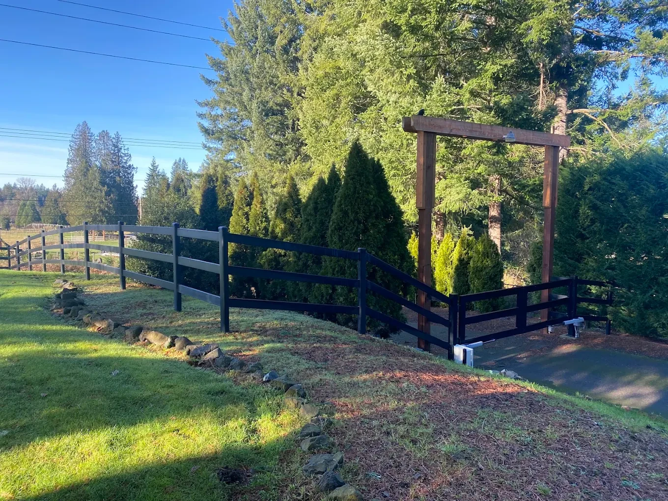 Ranch gate with evergreen trees